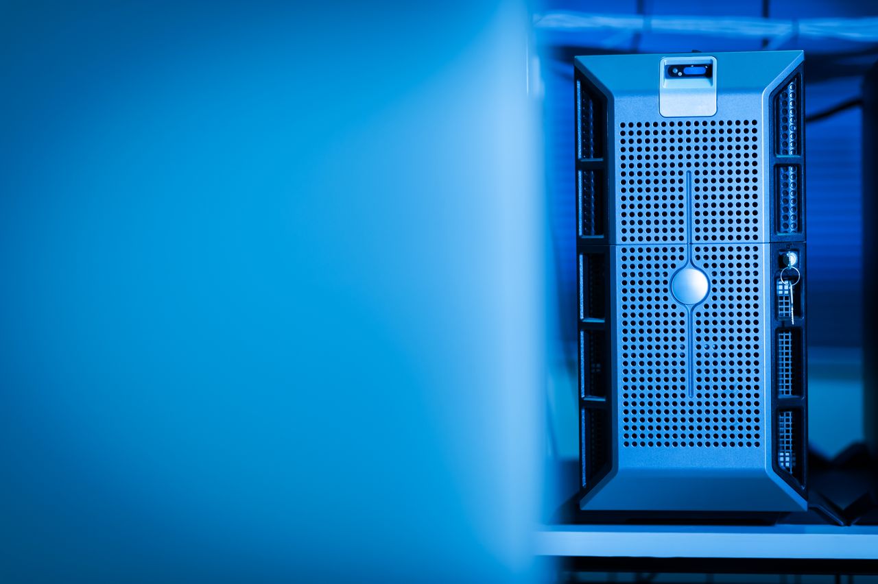 who-we-are Close-up of a modern server unit in a blue-lit data center environment.